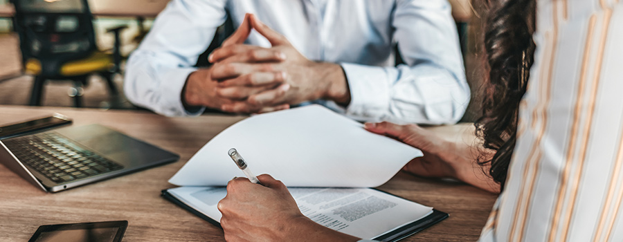 Hand filling out employee paperwork