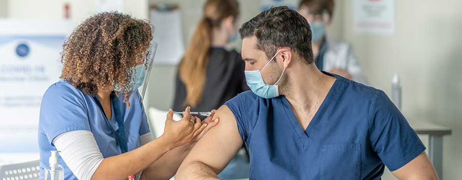 A nurse administrating a vaccine