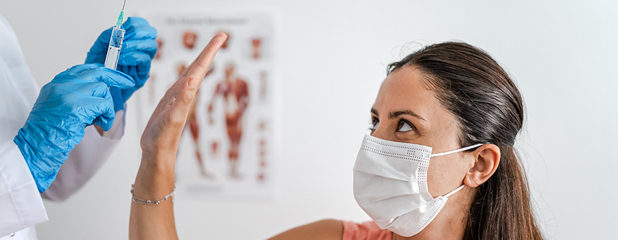 Women in doctor's office getting COVID-19 vaccine