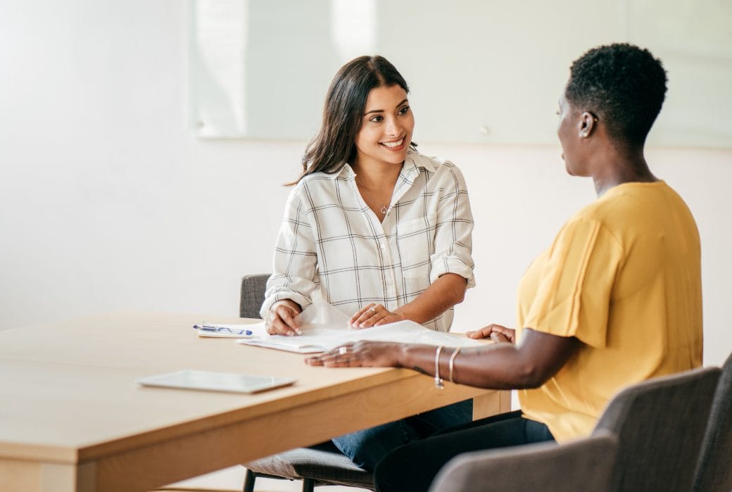Recruiter meeting with candidate during pre-employment screening interview process.