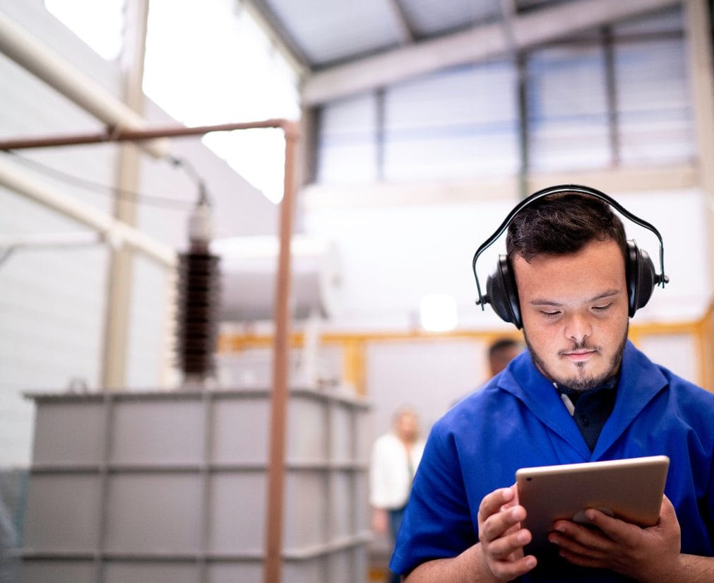 Retail employee using a tablet in a store environment, representing retail workforce and employment screening.
